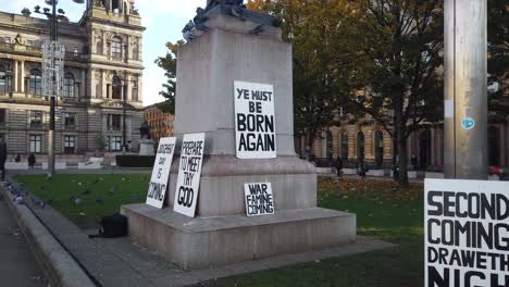 Banners-and-signs-about-the-end-of-the-world-in-George-Square,-Glasgow