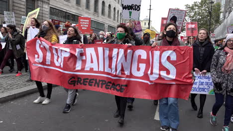 Greenpeace-protestors-with-a-red-banner-that-says,-“Stop-Failing-Us”-march-with-thousands-on-the-Global-Day-For-Climate-Justice-demonstration-as-the-Cop-26-summit-is-held-in-Glasgow