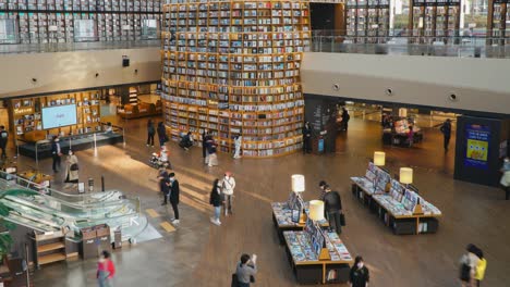 People-buying-books-and-searching-for-information-in-Starfield-Library---top-view-panning-timelapse