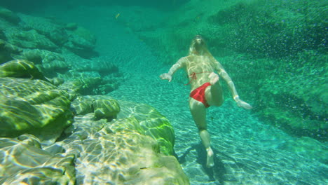 A-young-woman-enjoying-an-underwater-swim