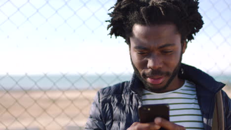 A-black-man-texting-on-social-media-using-a-phone