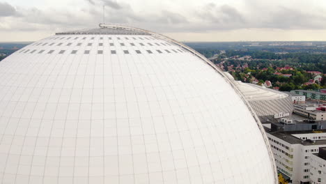 Avicii-arena-globe-with-majestic-view-of-Stockholm-city,-aerial-side-fly