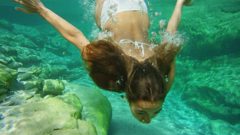 A-woman-in-a-white-bikini-swimming-in-a-lake