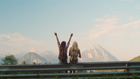 Two-women-looking-at-view.-Two-friends-celebrating