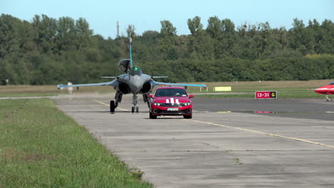RAFALE-SOLO-DISPLAY---Red-Car-Driving-In-Front-Of-Dassault-Rafale-Aircraft-At-Gdynia-Aerobaltic-2021-Airshow