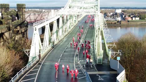 Charity-Santa-dash-fun-run-over-Runcorn-Silver-Jubilee-bridge-Aerial-static-view