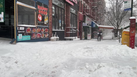 Delivery-Bike-Struggles-In-Deep-Snow-On-New-York-City-Sidewalk