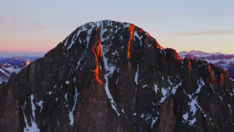 A-drone-rises-over-the-peaks-of-Cima-d'Asta-at-sunrise
