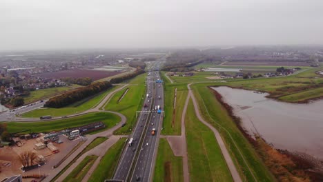 Aerial-Over-A15-Motorway-With-Traffic-Moving-Both-Ways-In-Hendrik-Ido-Ambacht