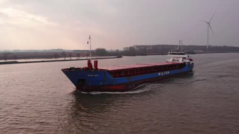 Aerial-View-Of-Wilson-Leith-Containership-Travelling-Along-Oude-Maas-In-Barendrecht