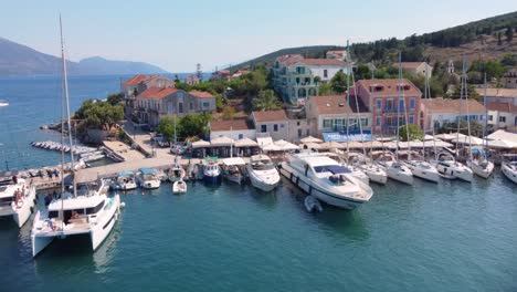 Sunny-bay-with-anchored-boats-in-foreground-and-waterfront-in-background-Fiscardo-Cephalonia