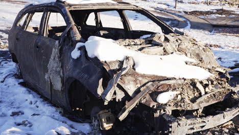 Snow-Covered-Burned-Down-And-Destroyed-SUV-Front-Exterior-Remains-in-Superior-Colorado-Boulder-County-USA-After-Marshall-Fire-Wildfire-Disaster