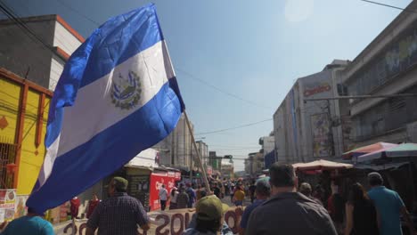 Salvadoran-flags-wave-during-a-peaceful-protest-in-the-city-streets-against-current-president-Nayib-Bukele---slow-motion
