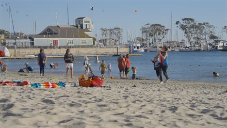 Two-kids-playing-paddle-ball-on-the-beach-in-Dana-Point,-California