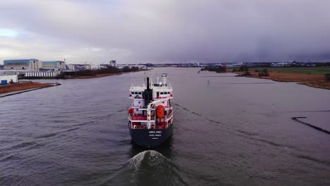 Aerial-Flying-Towards-Stern-Of-Ameland-Cargo-Ship-Along-Oude-Maas