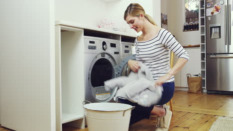 4k-footage-of-a-young-woman-removing-clean-laundry