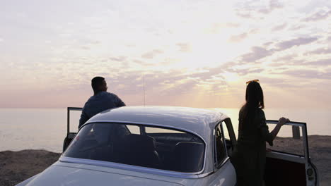 Sunset,-a-car-and-a-couple-on-a-road-trip