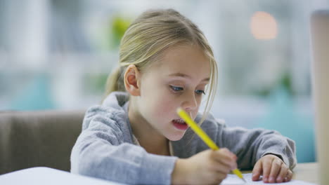 an-adorable-little-girl-doing-her-homework-at-home
