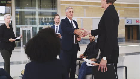 Teamwork-handshake-of-corporate-people-in-a-modern
