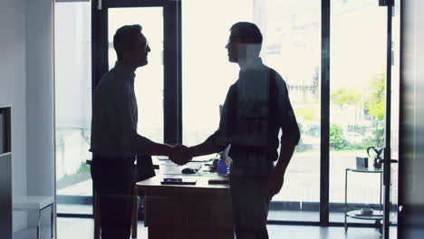 two-businessmen-shaking-hands-while-standing