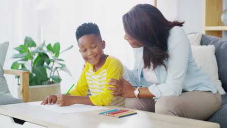 an-adorable-young-boy-drawing-with-his-mom-at-home