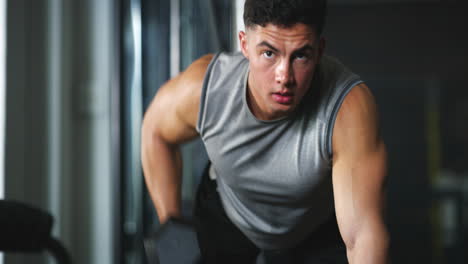 a-fit-young-man-working-out-with-dumbbells