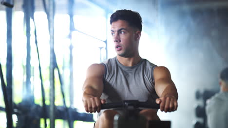 young-man-working-out-on-a-rowing-machine