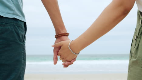 Back,-couple-and-holding-hands-at-beach