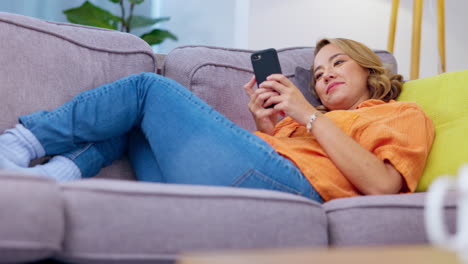 Laugh,-message-and-phone-with-woman-on-sofa