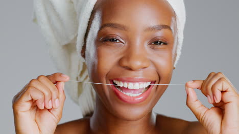 Smile,-dental-and-floss-with-black-woman-in-studio
