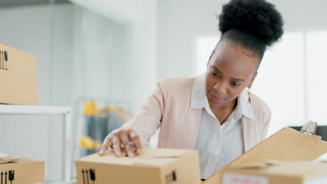 Black-woman,-logistics-and-inspection-on-boxes