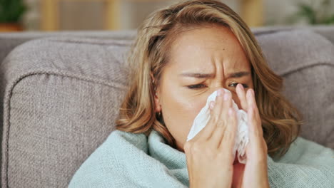 Sick-asian-woman-blowing-nose-in-home-for-allergy
