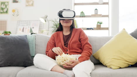VR,-watching-movies-and-woman-on-sofa-with-popcorn