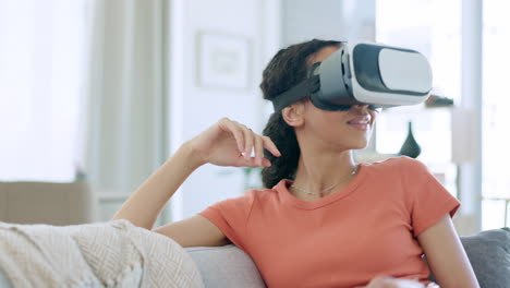 VR-goggles-of-happy-woman-on-sofa-in-metaverse