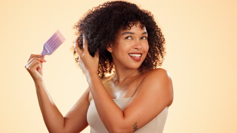 Face,-hair-care-and-woman-with-afro-comb-in-studio