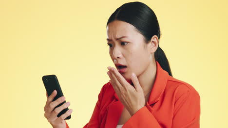 Asian-woman,-phone-and-shocked-for-bad-news
