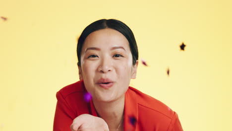 Studio,-asian-woman-blowing-confetti