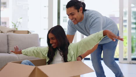 Moving,-box-and-a-homeowner-couple-playing