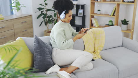 Dance,-phone-and-music-with-woman-on-sofa