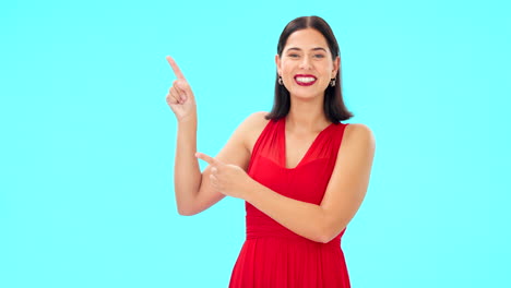 Smile,-face-and-woman-on-blue-background-pointing