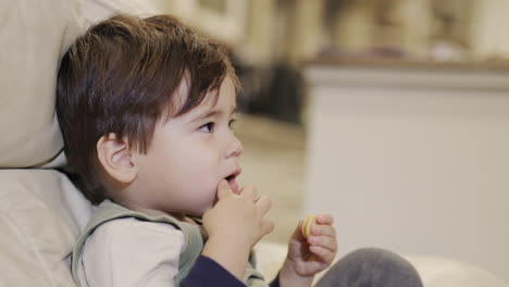 A-two-year-old-eats-crackers.-Unhealthy-junk-food-harmful-to-health