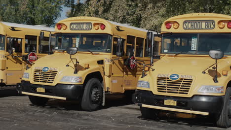 Wilson,-NY,-USA,-October-2021:-A-row-of-yellow-school-buses-stand-in-the-parking-lot