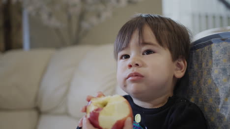 Little-kid-eats-a-big-red-apple