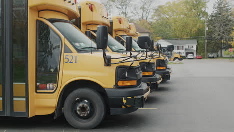 Wilson,-NY,-USA,-October-2021:-Row-of-yellow-school-buses-in-the-parking-lot-near-the-school