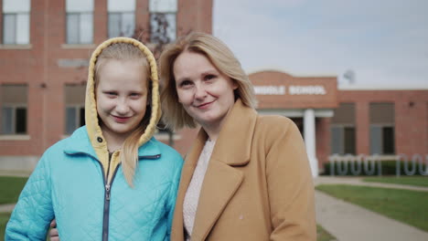 Portrait-of-a-mother-and-daughter-against-the-background-of-high-school