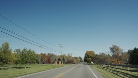 Drive-through-the-farming-region,-view-from-the-car-window.-Typical-landscape-with-American-farms