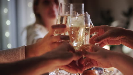 Happy-friendly-family-clinks-glasses-of-sparkling-wine-at-the-festive-table.-4k-video