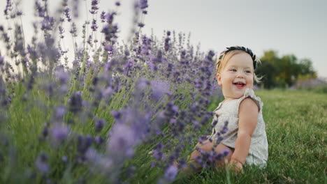 Portrait-of-a-cute-girl-sitting-near-lavender-bushes.