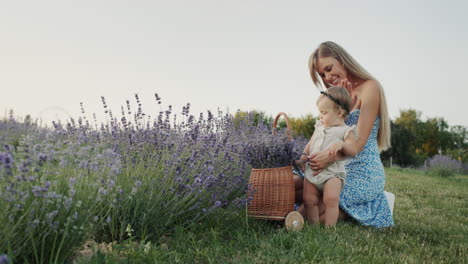 Mom-with-a-little-daughter-near-a-basket-with-lavender-in-a-lavender-field.-Beauty-and-health-concept