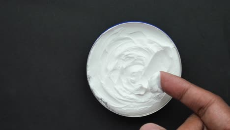 Man-applying-beauty-cream-onto-skin